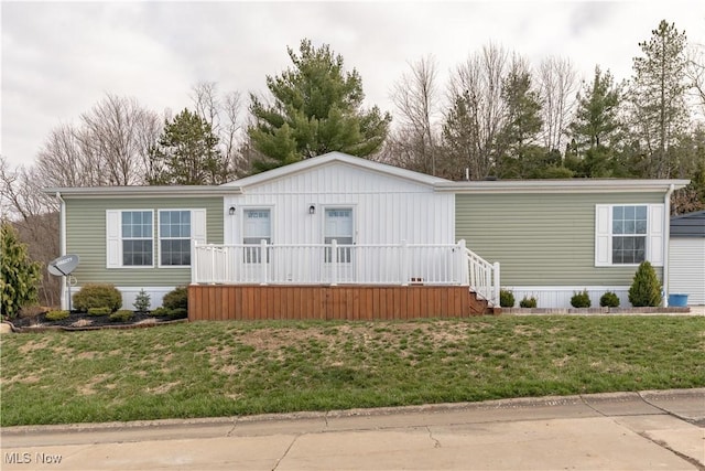 2409 Chelsea Dr SW, Canton, OH 44706 - manufactured / mobile home featuring a front lawn and a porch