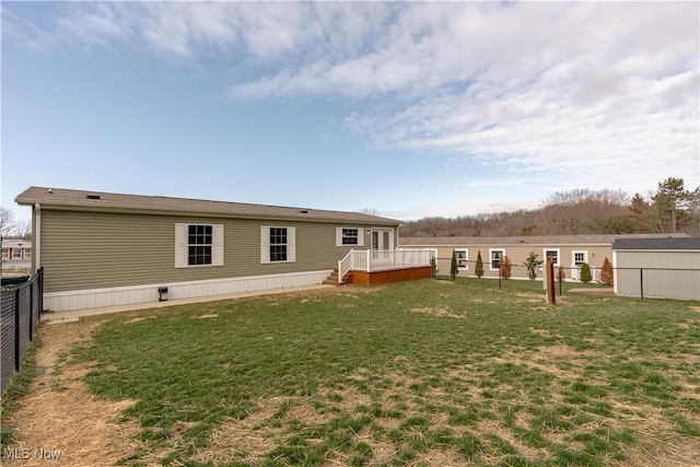 2409 Chelsea Dr SW, Canton, OH 44706 - rear view of house with a fenced backyard, a deck, and a yard