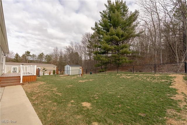 2409 Chelsea Dr SW, Canton, OH 44706 - view of yard featuring a fenced backyard, an outdoor structure, a storage unit, and a deck
