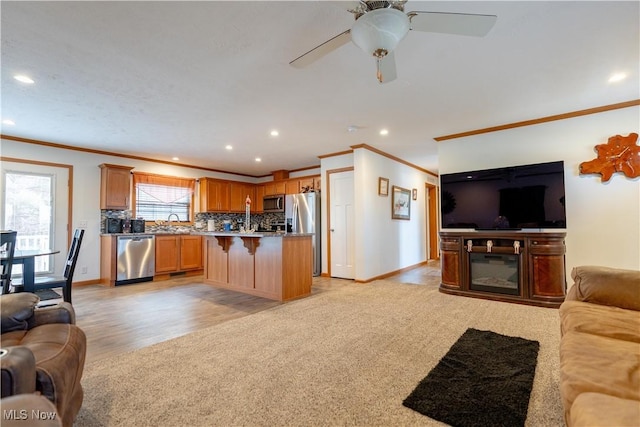 2409 Chelsea Dr SW, Canton, OH 44706 - living area with baseboards, ornamental molding, a ceiling fan, and light colored carpet