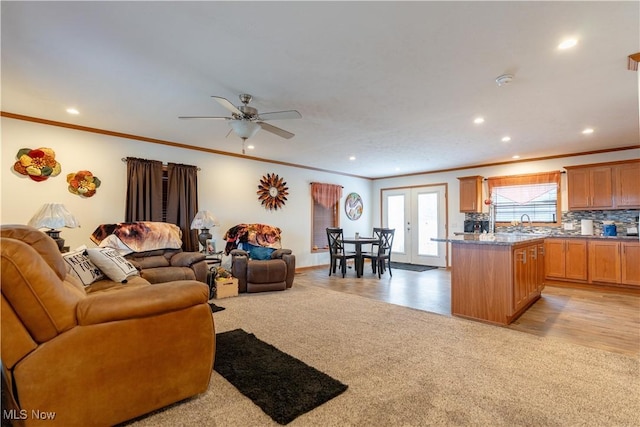2409 Chelsea Dr SW, Canton, OH 44706 - living area with a ceiling fan, light wood-type flooring, recessed lighting, light colored carpet, and ornamental molding