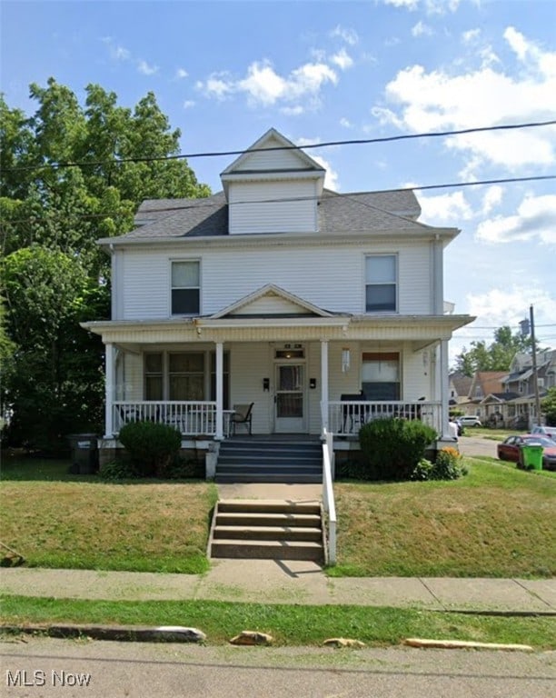 traditional style home with a porch and a front yard