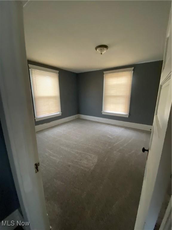 unfurnished bedroom featuring baseboards and carpet floors