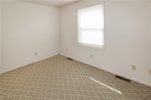 424 Short Prt, Clinton, OH 43452 - spare room with baseboards, visible vents, and light carpet