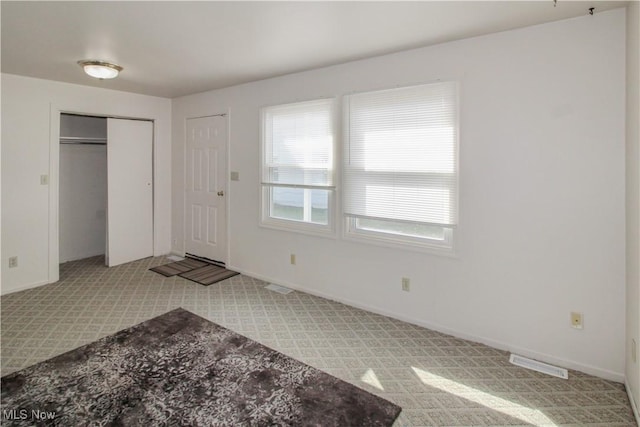 424 Short Prt, Clinton, OH 43452 - foyer entrance with light colored carpet, visible vents, and baseboards