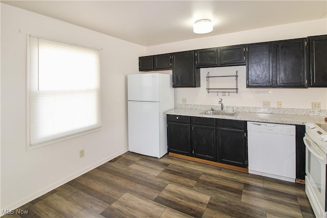 424 Short Prt, Clinton, OH 43452 - kitchen featuring light countertops, white appliances, dark cabinetry, a sink, and dark wood-style floors