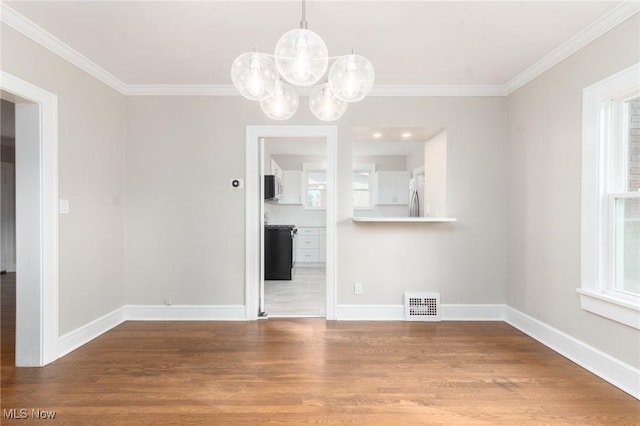 3459 Helen Rd, Shaker Heights, OH 44122 - unfurnished dining area featuring visible vents, baseboards, ornamental molding, wood finished floors, and an inviting chandelier