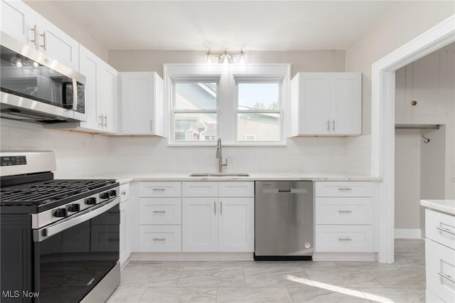 3459 Helen Rd, Shaker Heights, OH 44122 - kitchen featuring white cabinetry, marble finish floor, a sink, and appliances with stainless steel finishes