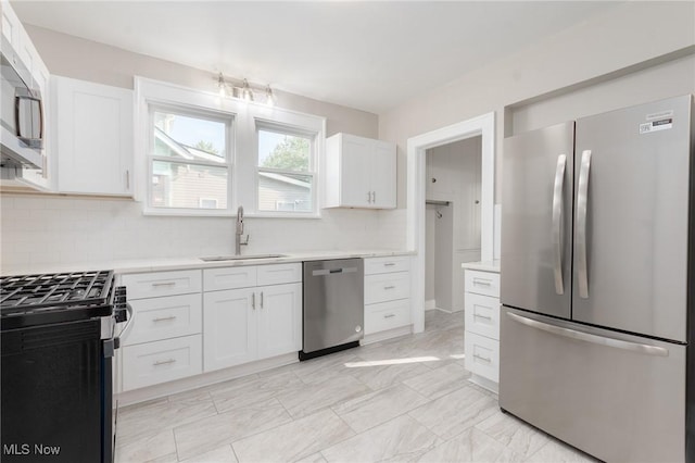3459 Helen Rd, Shaker Heights, OH 44122 - kitchen featuring a sink, backsplash, white cabinets, and appliances with stainless steel finishes