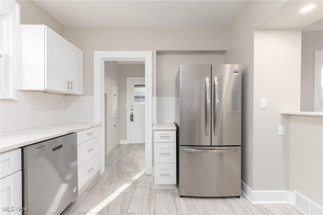 3459 Helen Rd, Shaker Heights, OH 44122 - kitchen with white cabinetry, stainless steel appliances, backsplash, light stone counters, and visible vents