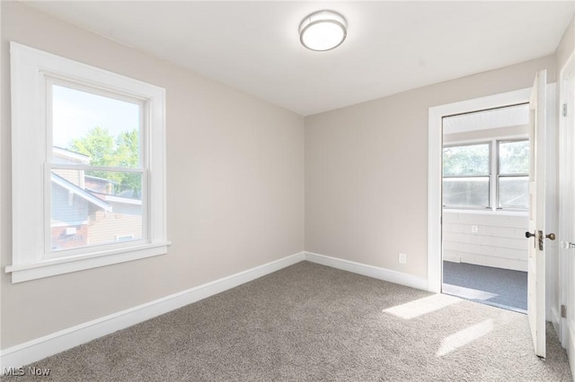 3459 Helen Rd, Shaker Heights, OH 44122 - unfurnished bedroom featuring baseboards, carpet flooring, connected bathroom, and multiple windows