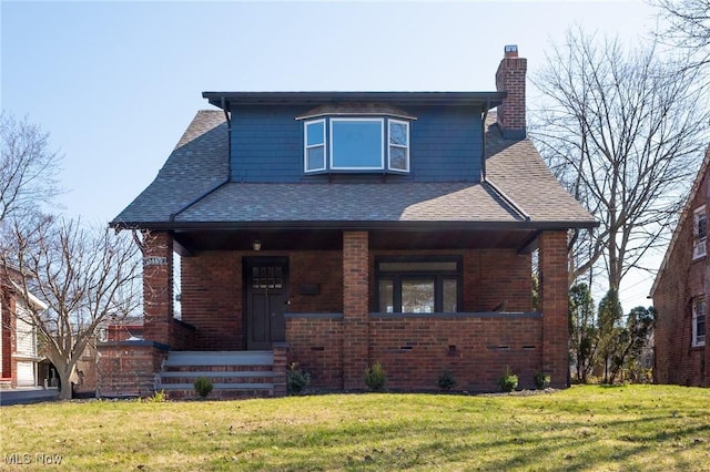 3459 Helen Rd, Shaker Heights, OH 44122 - view of front of property with a chimney, a front yard, brick siding, and roof with shingles