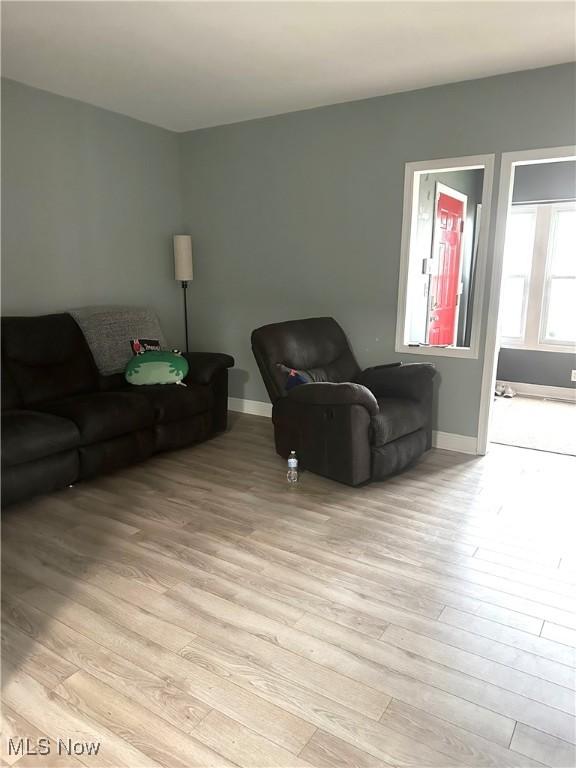 living area with light wood finished floors and baseboards