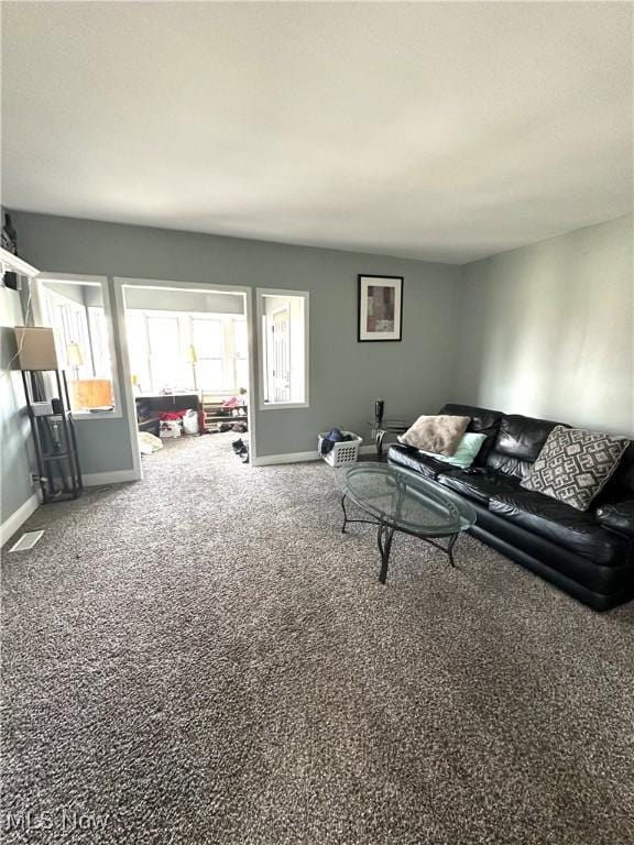 carpeted living room featuring baseboards and visible vents
