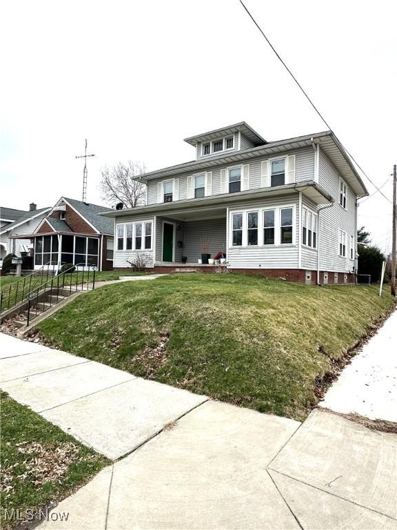 traditional style home with a front yard