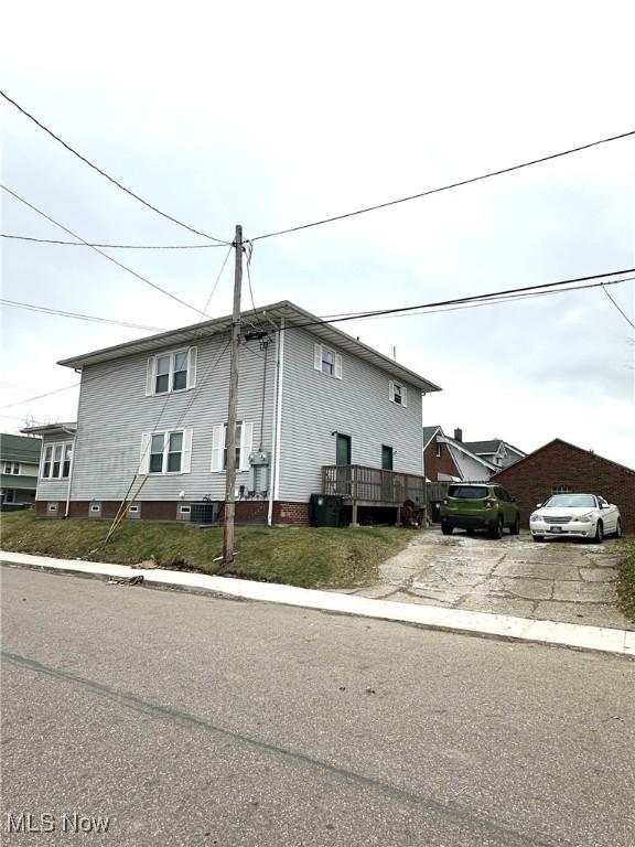 view of side of home featuring driveway