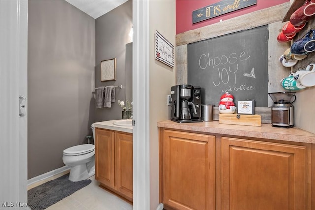 bar area with light tile patterned floors and baseboards