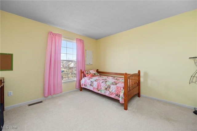 carpeted bedroom featuring baseboards