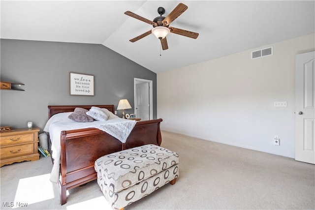 carpeted bedroom with vaulted ceiling and a ceiling fan