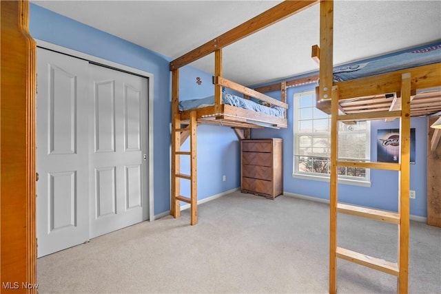 unfurnished bedroom with carpet floors and baseboards