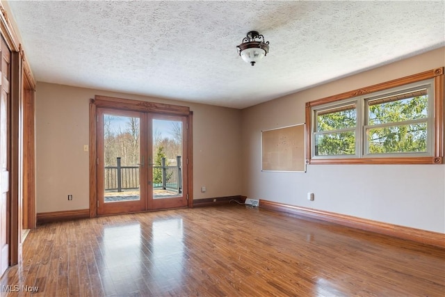 3871 Foskett Rd, Medina, OH 44256 - unfurnished room featuring baseboards, wood finished floors, french doors, and a textured ceiling