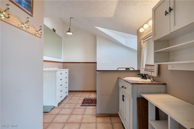 3871 Foskett Rd, Medina, OH 44256 - bathroom featuring lofted ceiling, a textured ceiling, tile patterned floors, and vanity