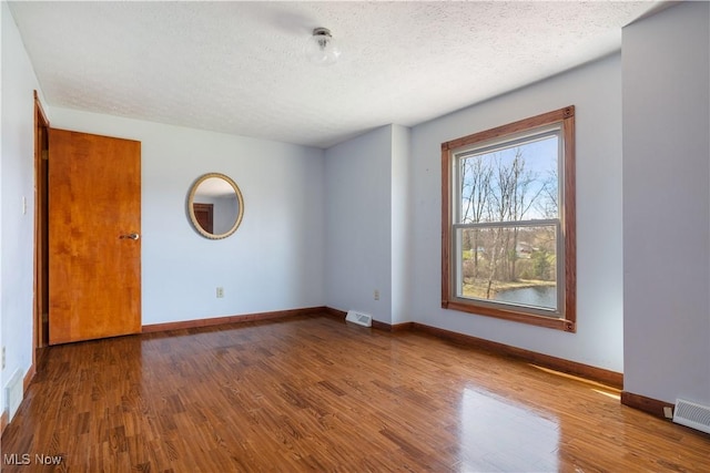 3871 Foskett Rd, Medina, OH 44256 - spare room with wood finished floors, a textured ceiling, and visible vents