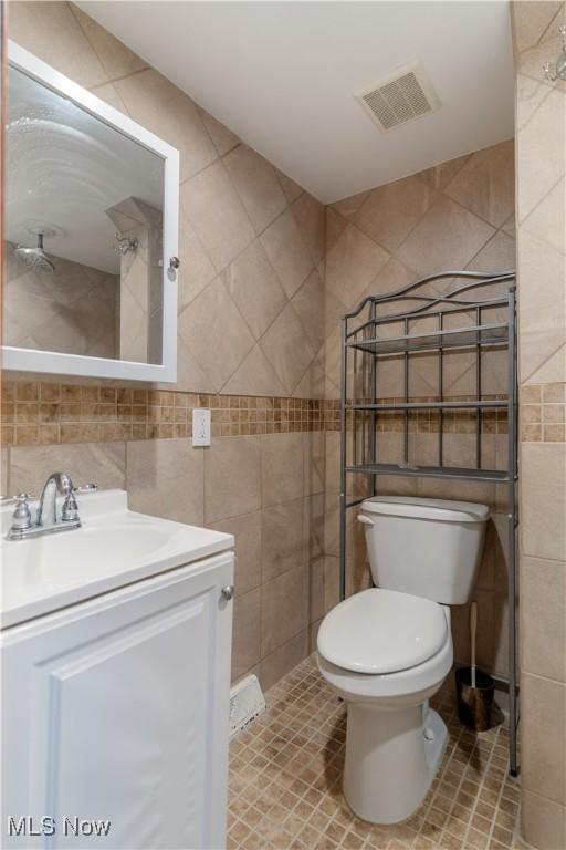 3871 Foskett Rd, Medina, OH 44256 - bathroom featuring toilet, vanity, tile walls, and visible vents