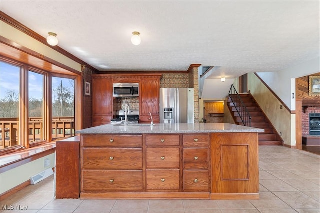 3871 Foskett Rd, Medina, OH 44256 - kitchen featuring a kitchen island with sink, visible vents, brown cabinets, and appliances with stainless steel finishes