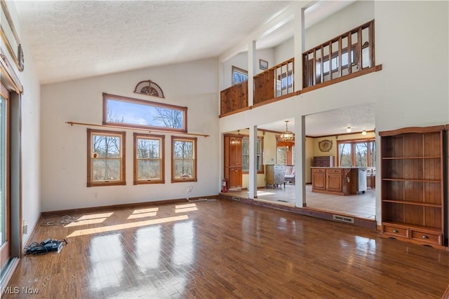 3871 Foskett Rd, Medina, OH 44256 - unfurnished living room with baseboards, a textured ceiling, and wood finished floors