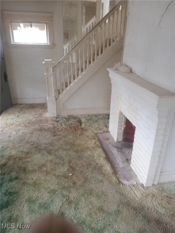 interior space featuring carpet floors and a fireplace