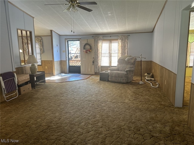 7280 US Route 322, Williamsfield, OH 44093 - unfurnished room with a wainscoted wall, carpet flooring, wood walls, ornamental molding, and a ceiling fan