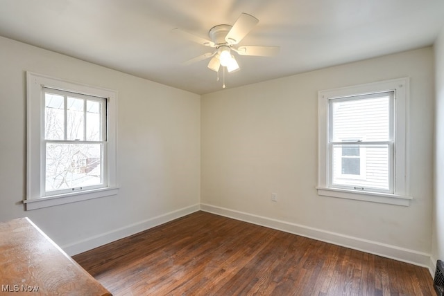 3596 W 155th St, Cleveland, OH 44111 - empty room with healthy amount of natural light, dark wood-type flooring, and a ceiling fan
