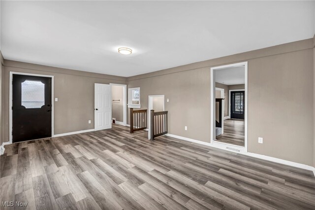 interior space with baseboards and wood finished floors
