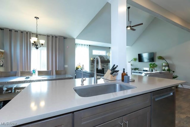 kitchen with open floor plan, a sink, gray cabinets, stainless steel dishwasher, and high vaulted ceiling