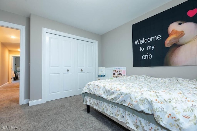 bedroom featuring carpet, a closet, and baseboards