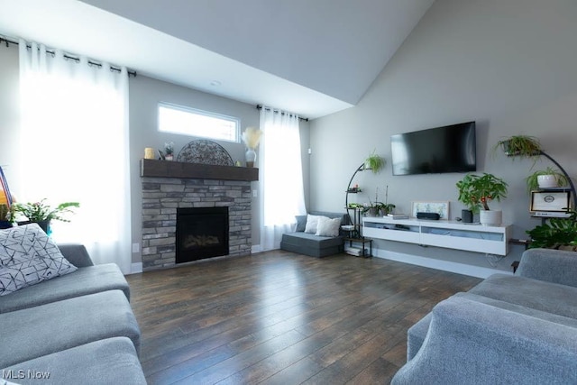 living room featuring hardwood / wood-style flooring, a fireplace, and high vaulted ceiling