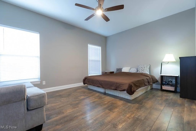 bedroom with hardwood / wood-style floors, baseboards, multiple windows, and a ceiling fan