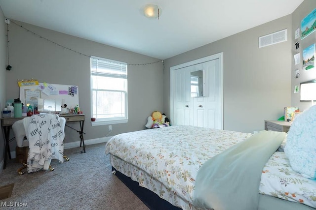 bedroom with carpet, baseboards, and a closet