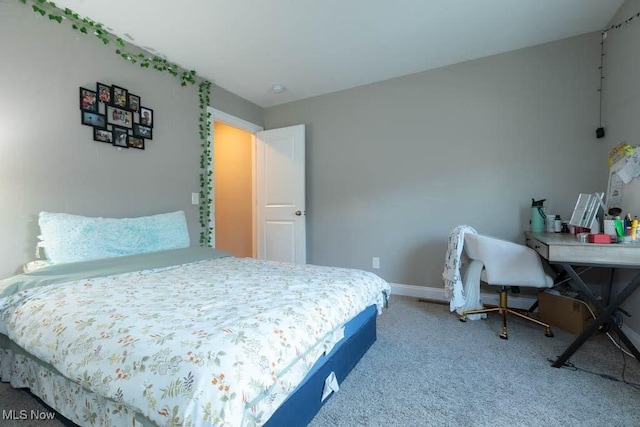 bedroom with carpet floors and baseboards