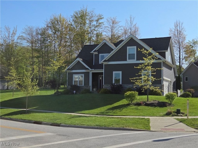 view of front facade featuring stone siding and a front yard