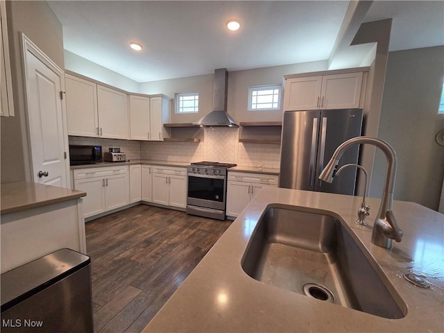 226 Hidden Glen Trl, Chardon, OH 44024 - kitchen featuring stainless steel appliances, wall chimney range hood, decorative backsplash, dark wood finished floors, and light countertops