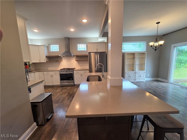 226 Hidden Glen Trl, Chardon, OH 44024 - kitchen with stainless steel appliances, wall chimney range hood, dark wood-style flooring, backsplash, and a chandelier