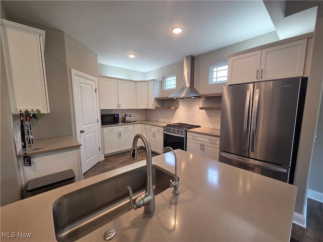 226 Hidden Glen Trl, Chardon, OH 44024 - kitchen with stainless steel appliances, wall chimney range hood, decorative backsplash, recessed lighting, and white cabinets