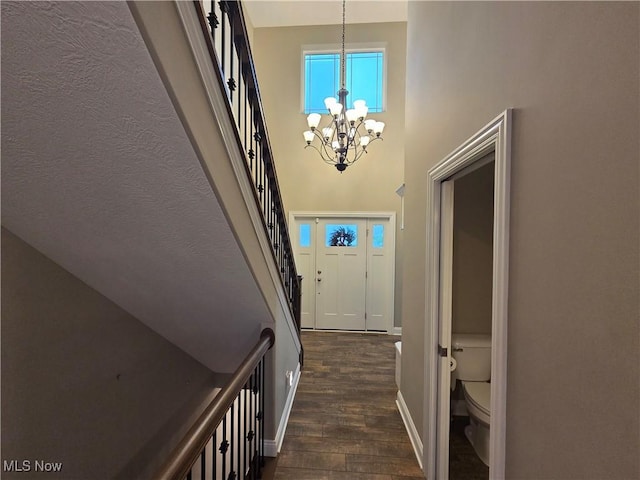 226 Hidden Glen Trl, Chardon, OH 44024 - corridor featuring a chandelier, dark wood-style floors, a towering ceiling, and stairway