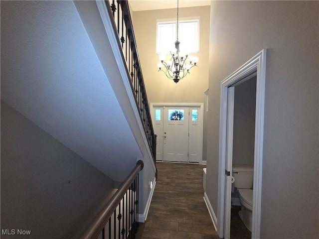226 Hidden Glen Trl, Chardon, OH 44024 - doorway with a chandelier, a high ceiling, stairs, and dark wood-style floors