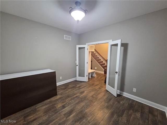 226 Hidden Glen Trl, Chardon, OH 44024 - empty room with french doors, dark wood-style floors, and stairs