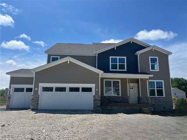 32005 Westview Trl, Avon Lake, OH 44012 - craftsman inspired home with a garage, stone siding, a porch, and roof with shingles
