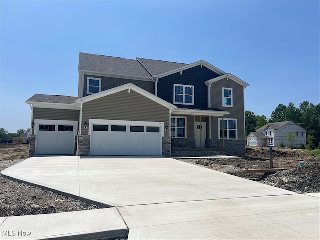 32005 Westview Trl, Avon Lake, OH 44012 - craftsman-style house with a garage, covered porch, stone siding, and driveway