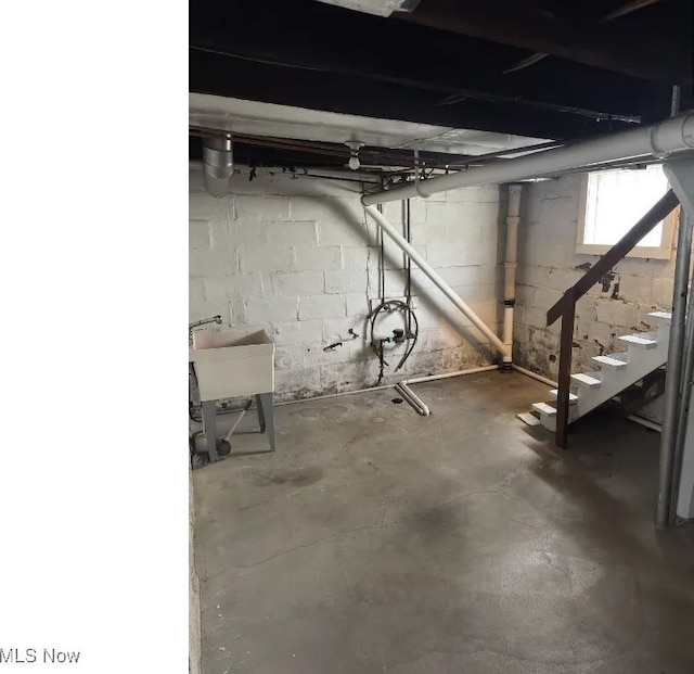below grade area featuring a sink and stairs